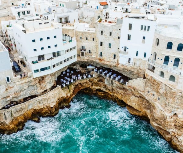 Stunning cliffside hotel in Polignano a Mare, overlooking the vibrant Adriatic Sea.