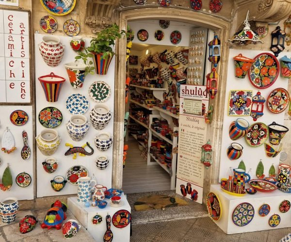 Vibrant display of artistic ceramics at a shop entrance in Ostuni, Włochy.