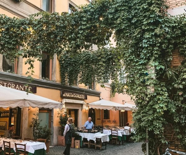 pexels-photo-2993065-2993065 Charming cafe with ivy-covered facade and outdoor seating in Rome, Italy.