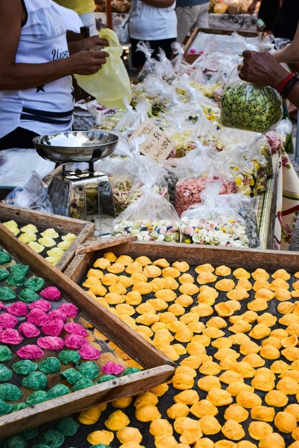 Colorful handmade pasta and market scene in Apulia, Italy showcasing local culture.