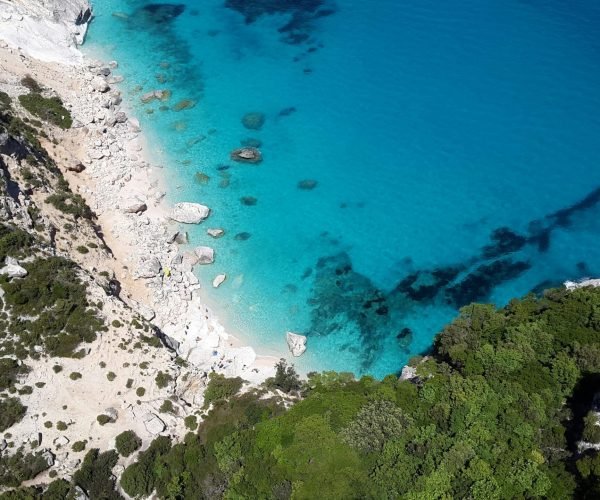 Stunning aerial shot of Cala Goloritzé, Sardinia with turquoise waters and rocky coastline.